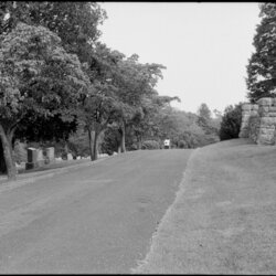 A cemetery with a person in the distance.
