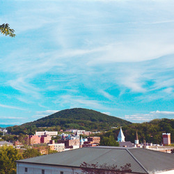 A city with a hill in the background.
