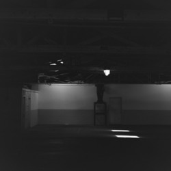 A dim garage with shafts of daylight.
